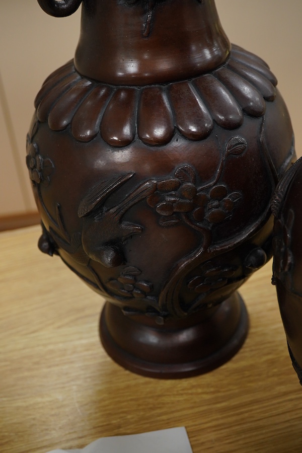 A large pair of Japanese bronze vases, early 20th century, decorated in relief with birds and flowers, 45cm high